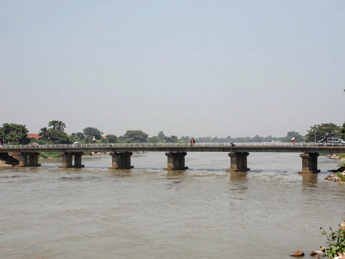 Editorial documentary photograph of a river crossing and road bridge in peninsular India at midday, natural daylight, ne